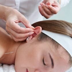 beautiful-woman-relaxing-bed-having-acupuncture-treatment-with-needles-around-her-ear-1536x1025