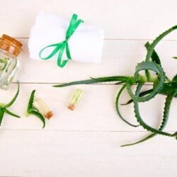 aloe-vera-oil-glass-bottle-towel-spa_120485-5987