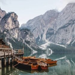 idyllic-shot-of-wooden-boats-docked-near-a-boathou-2023-01-19-18-24-45-utc