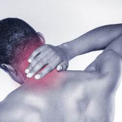 feeling-pain-his-neck-rear-view-young-muscular-african-man-touching-his-neck-while-standing-against-grey-background_425904-36316